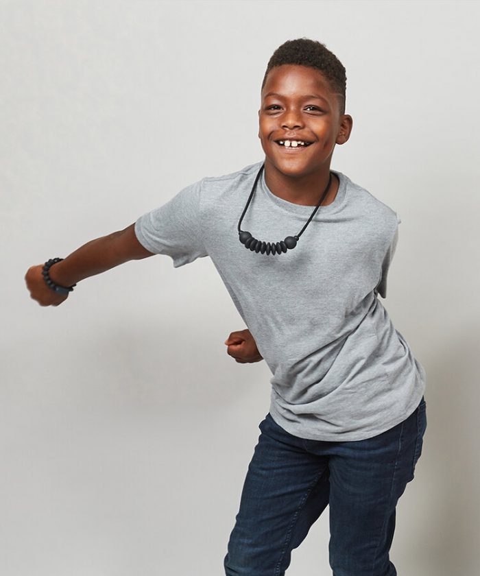 A kid dancing and wearing the charcoal sensory bracelet